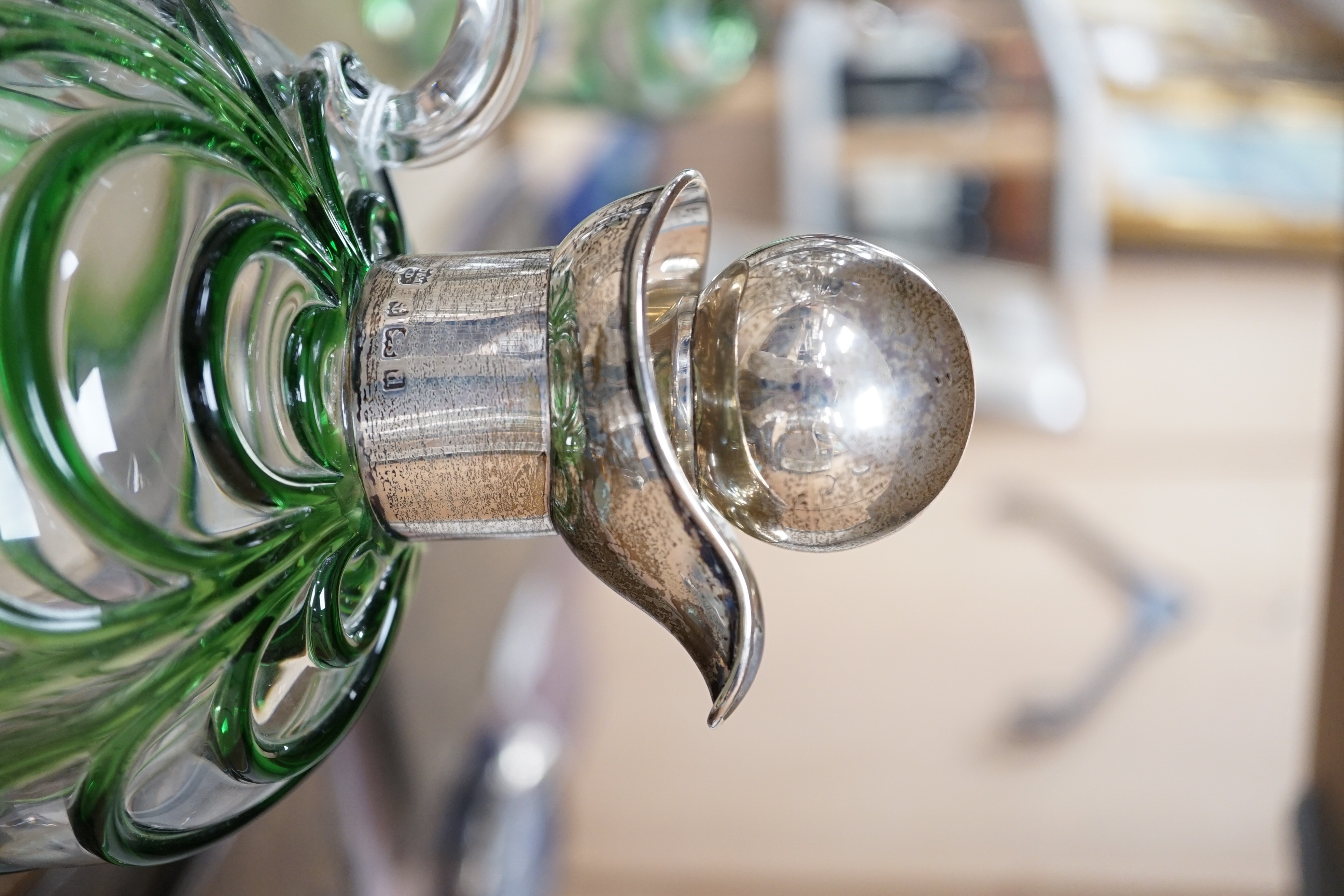 A late Victorian Art Nouveau silver mounted glass claret jug and stopper, D & M Davis, Birmingham, 1900, the glass with ribbed green swags, height 20.7cm.